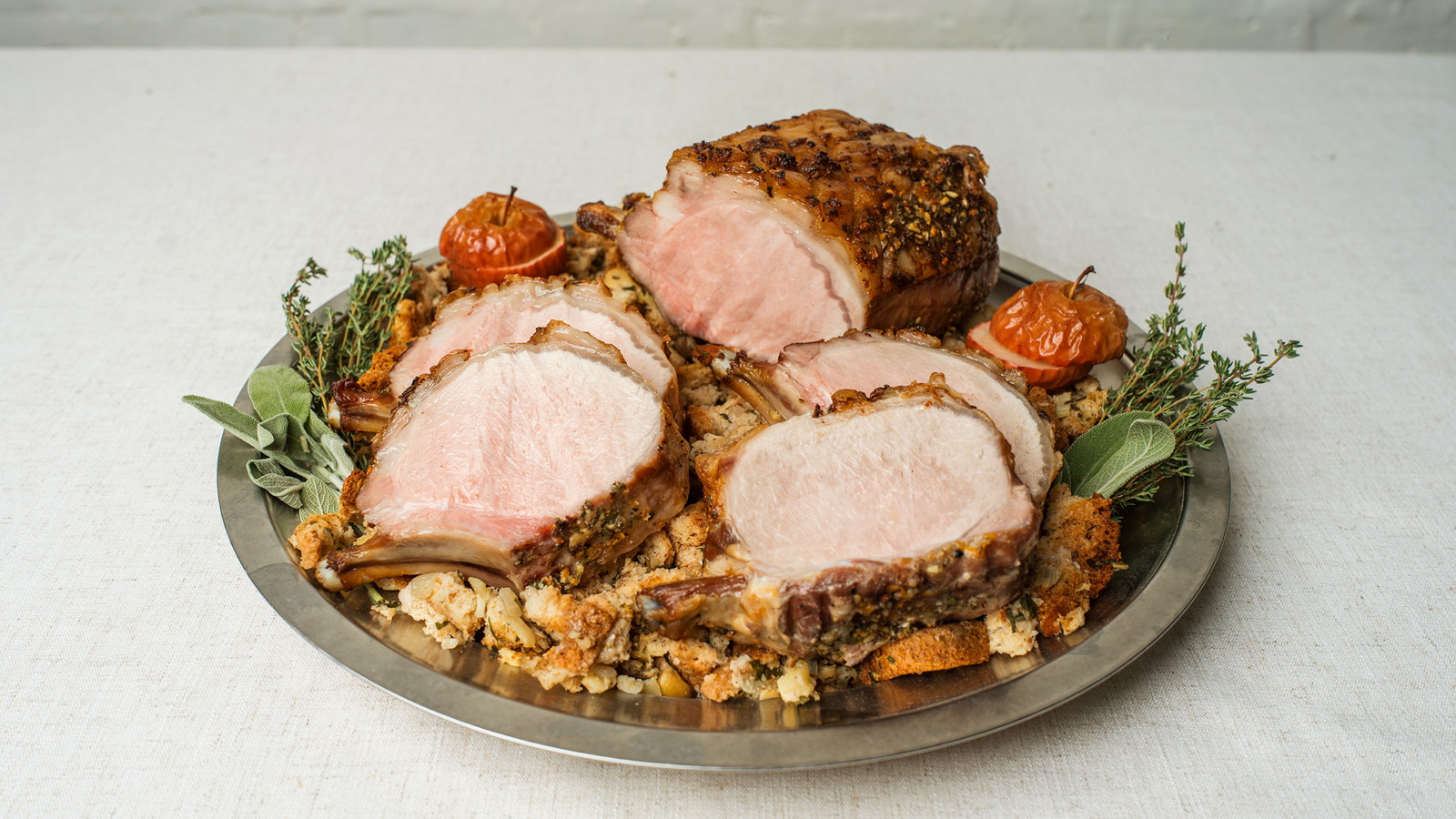 sliced roasted rack of pork plated with stuffing 