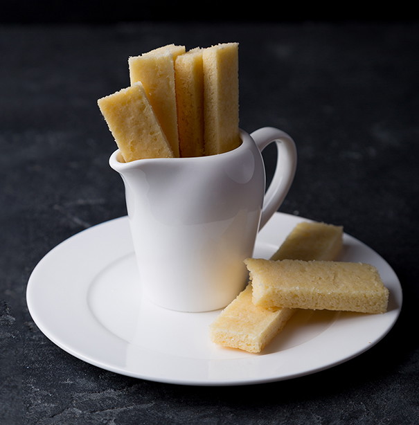 Homemade shortbread bars served in a white pitcher.