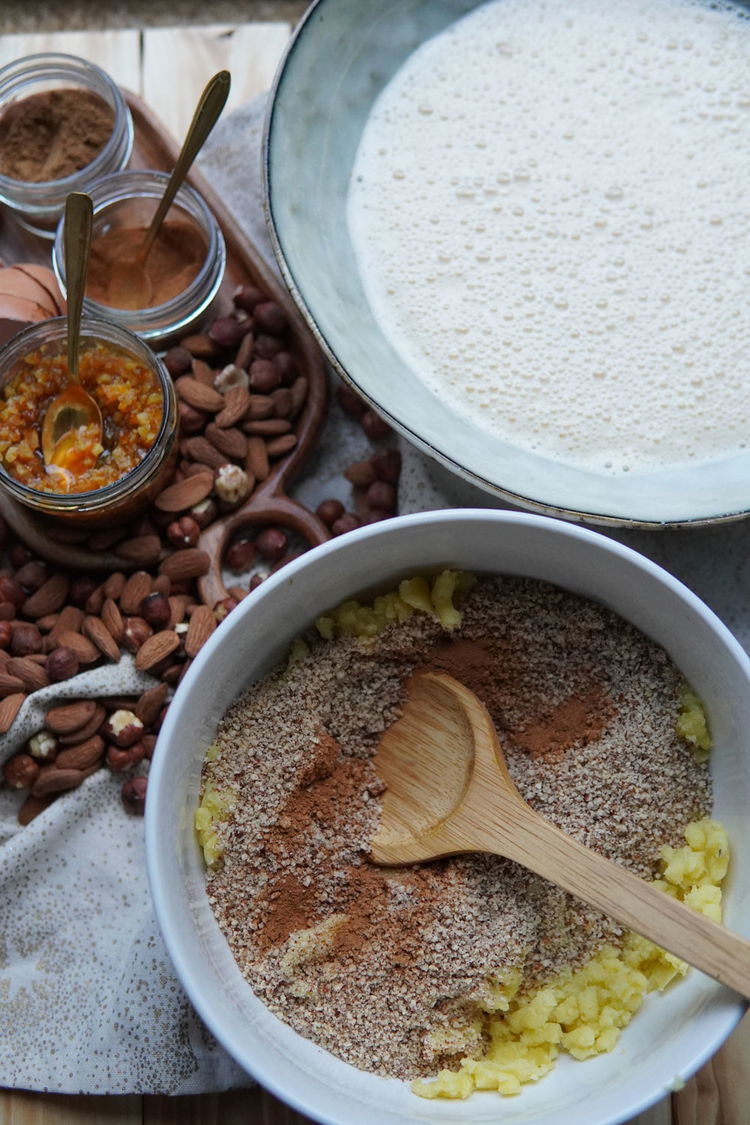 Image of Die gemahlenen Nüsse, Zimt, Lebkuchengewürz, Natron und den Kartoffelstampf miteinander...