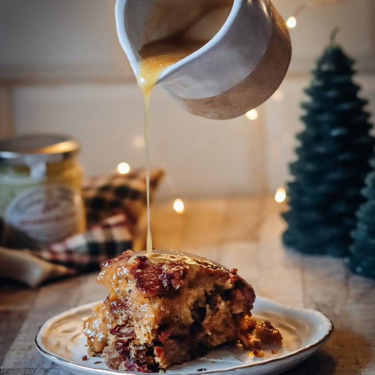 Image of Poke holes in the warm pudding
and pour half the sauce over the top. Serve with the rest on the side and a
scoop of vanilla ice cream.