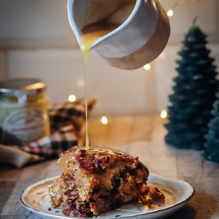 Image of Poke holes in the warm pudding and pour half the...