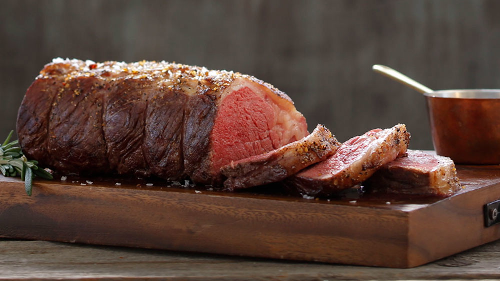Manhattan Roast on cutting board with copper dish