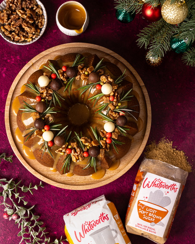 A salted caramel cake moulded in a wreath shape, decorated with berries and nuts