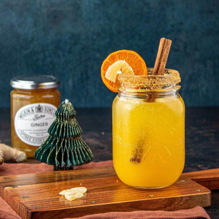 Image of Cut a slit in one side of a slice of clementine and add it upright to the edge of the glass. Cut a slit in a piece of crystallised ginger and slide it onto the rim of the glass. Stir...