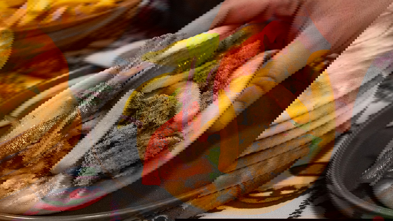 A Kebab of seasoned halal beef, topped with Lebanese salata, tomato, onion, and fries served on a golden pita.