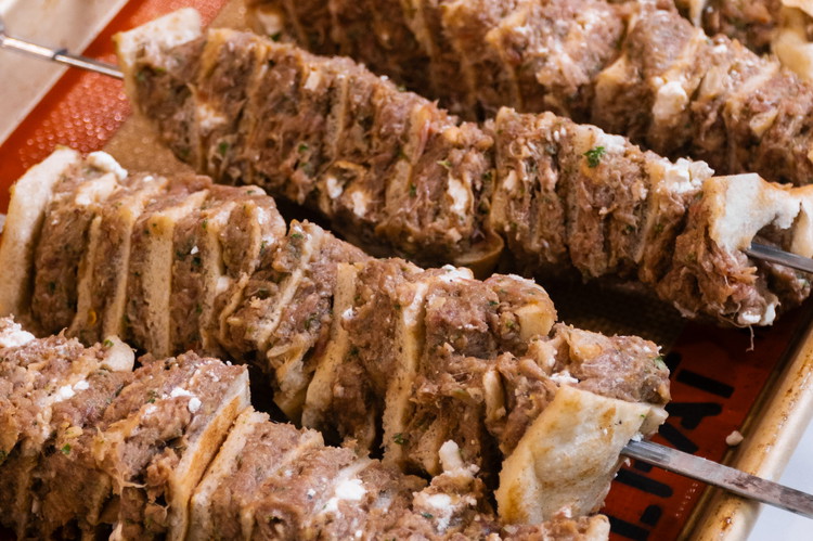 Image of Cut the stack in half and stack it back on top of itself again until you have a good 6-8 inch stack of layered meat and pita. I’m still not sure of the best way to do this next step....