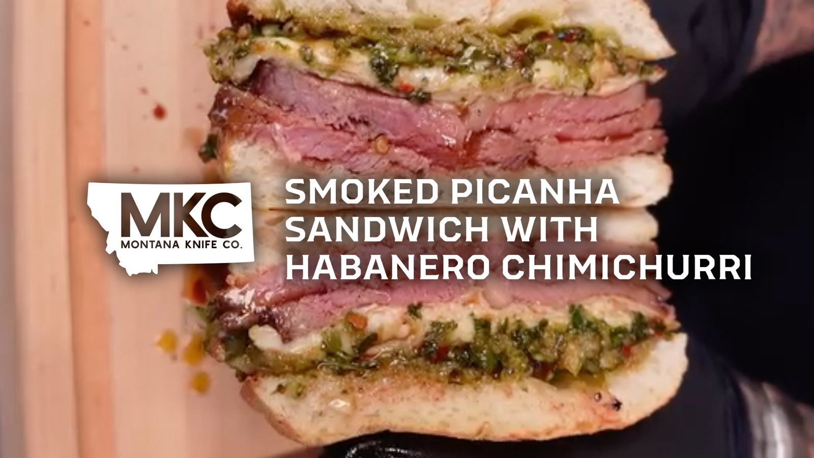 Smoked picanha chimichurri sandwich on toasted ciabatta with melted provolone cheese and fresh herbs.