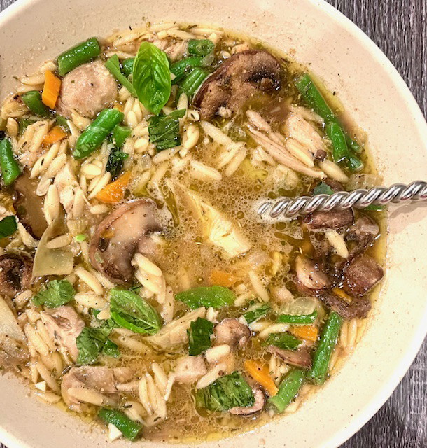 Image of Athena's Lemon Orzo Soup with chicken and herbs.