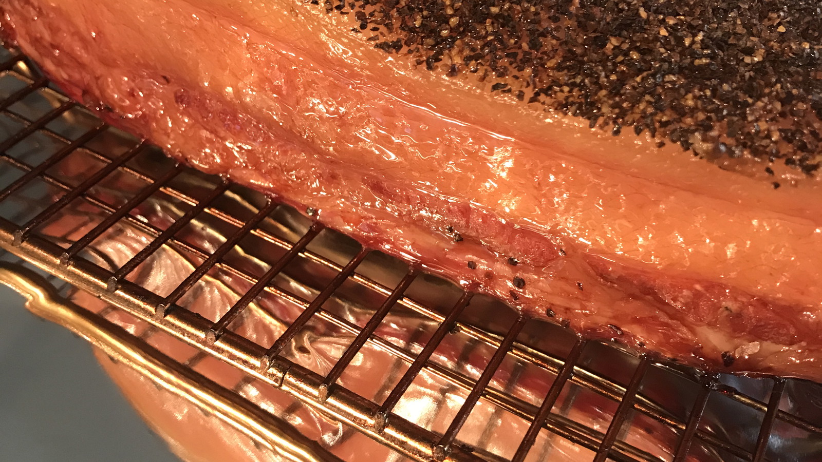 Freshly Smoked Bacon on wire rack on foil