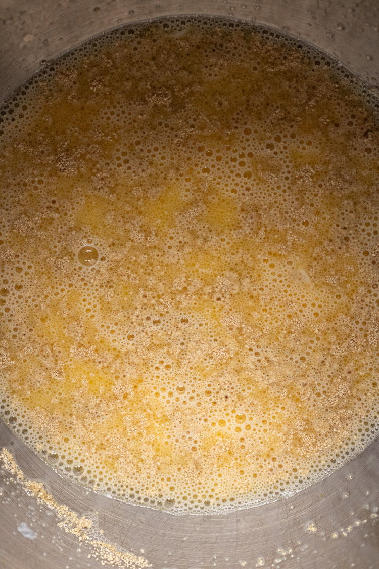 Image of In a large bowl or mixing bowl combine warm milk,...