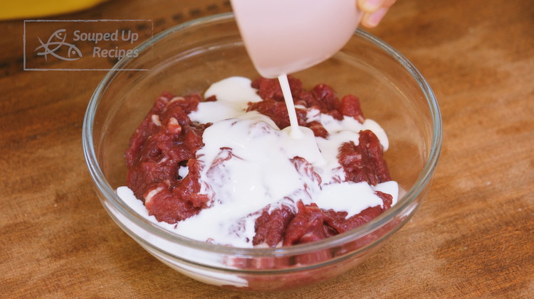 Image of Quickly mix 2.5 tbsp of cornstarch and 2 tbsp of water until no lumps, and pour it into the beef. Stir until all the mixture is absorbed. Drizzle in 2 tbsp of oil and mix to coat the beef. This...