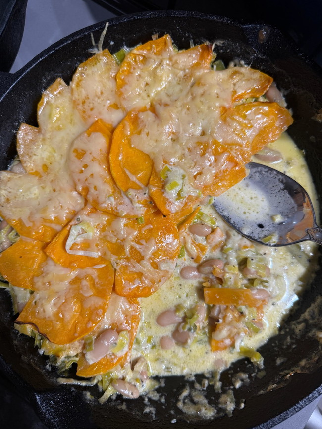 butternut squash leek and white bean gratin covered in melted cream and gruyere cheese