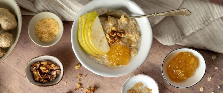 Image of To assemble, pour the porridge into a breakfast bowl, top with the sliced pears and the Ginger Conserve. Crumble the walnuts over the top, finishing with a sprinkling of Demerara sugar.