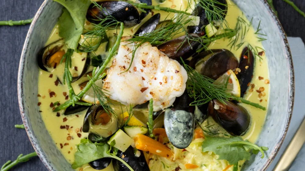 Image of Cremet fiskesuppe med torsk, laks og store rejer.