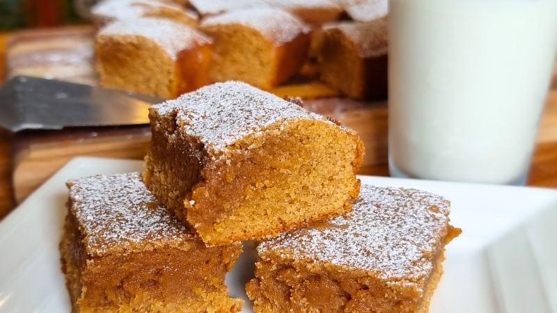 Gingerbread Brownies made with Black Honey on a plate with glass of milk beside