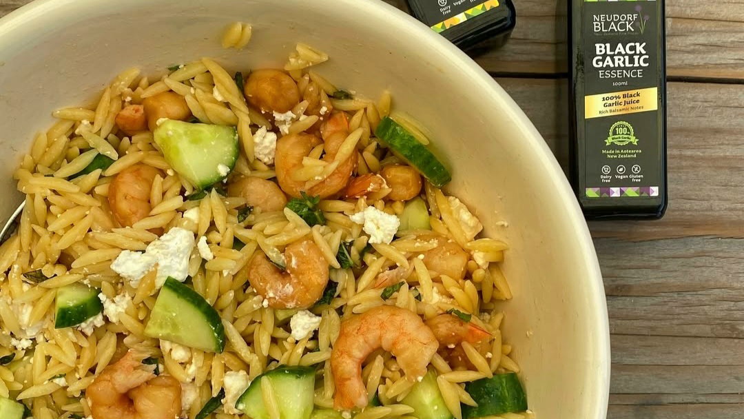 Black Garlic Prawn Orzo Salad with Feta and Cucumber in a bowl