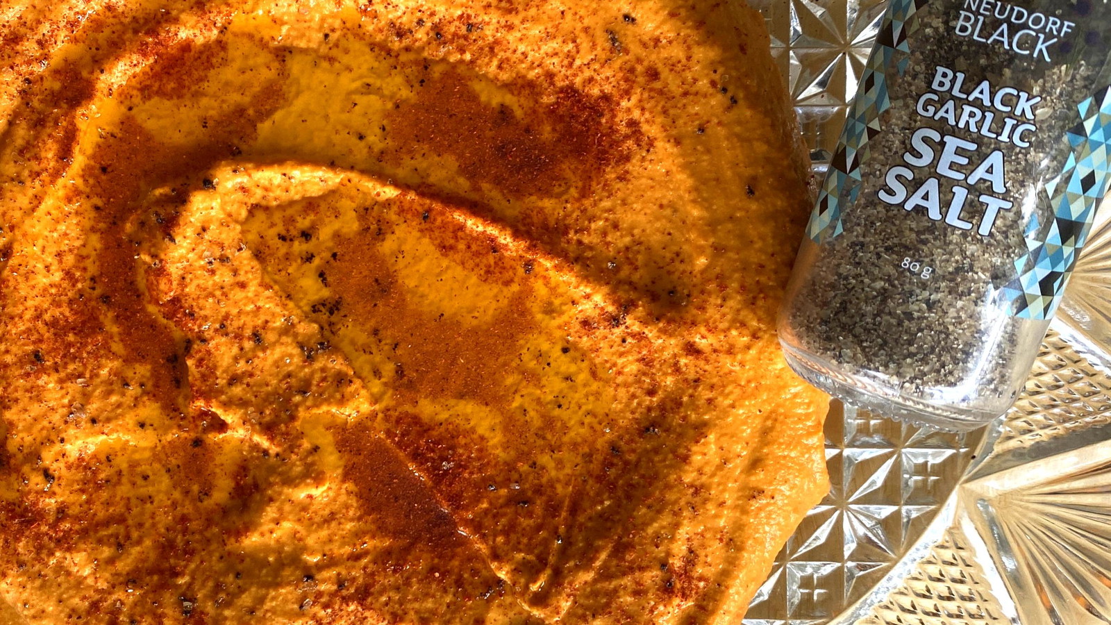 Smoky Capsicum Hummus with Black Garlic Salt shaker beside
