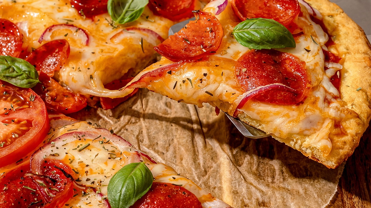 A slice of keto pizza made with lupin flour pizza crust.