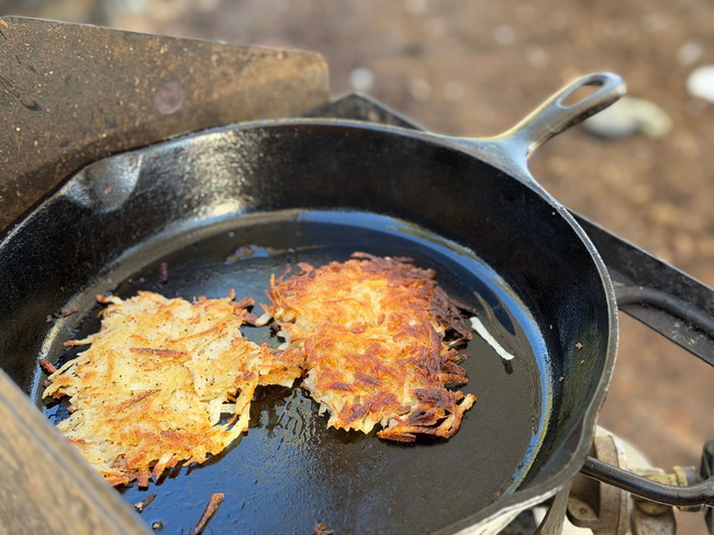 Crispy Hash Browns Golden Brown in a Cast Iron Skillet outside grill