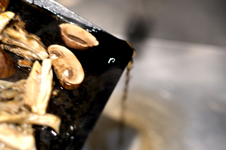 Image of CAREFULLY pull mushrooms from oven and drain out the water...