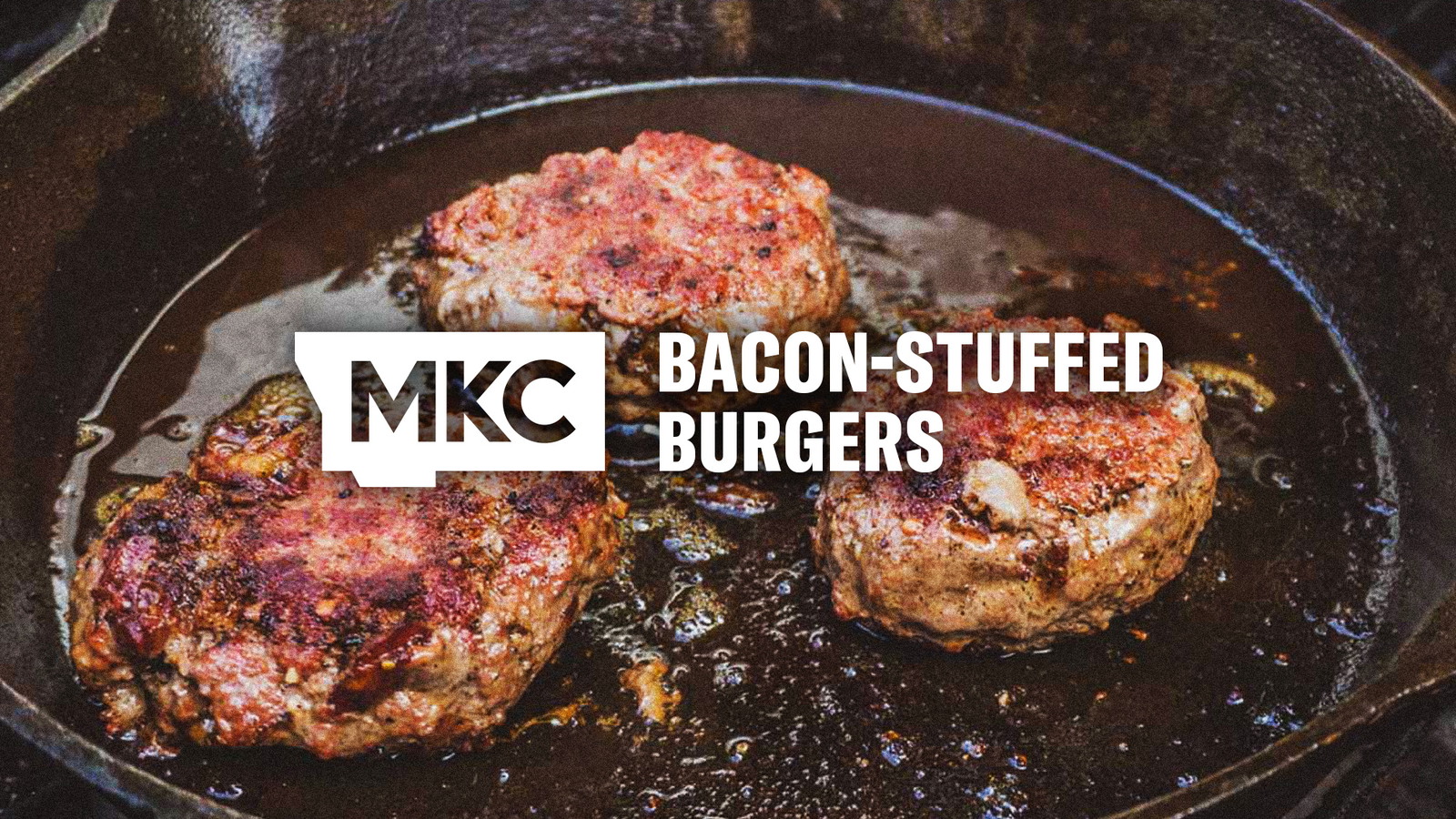 Three bacon‑stuffed burgers sizzling in a cast iron skillet, seared in bacon grease for a smoky, crispy finish.
