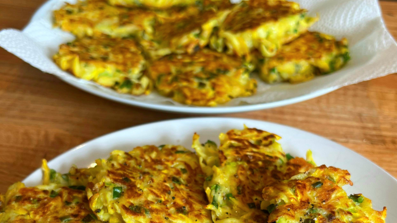 zucchini fritters sprinkled with black garlic sea salt on a plate