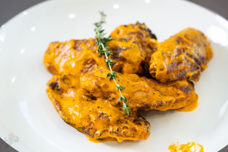 Image of Pour two-thirds of the peanut sauce over the wings and...