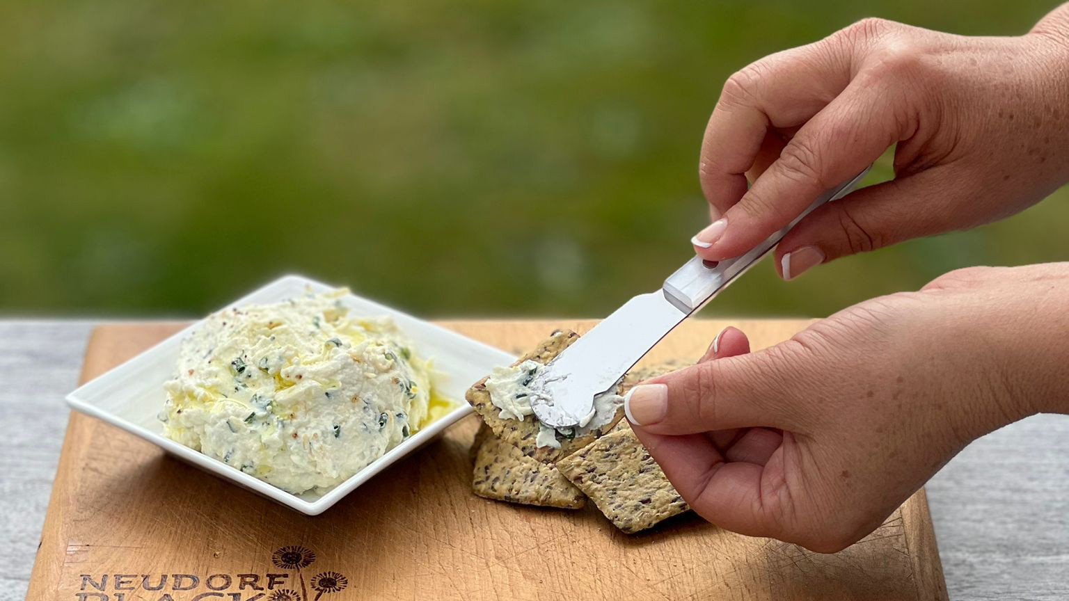 Herbed Ricotta with Black Garlic Olive Oil on crackers