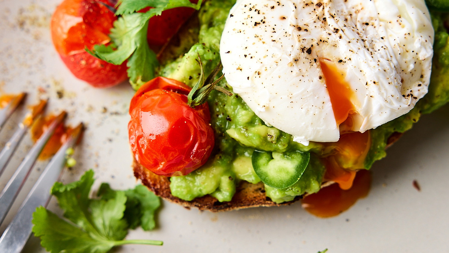 Image of Smashed Jalapeno Avocado Toast with Poached Egg & Roasted Tomatoes