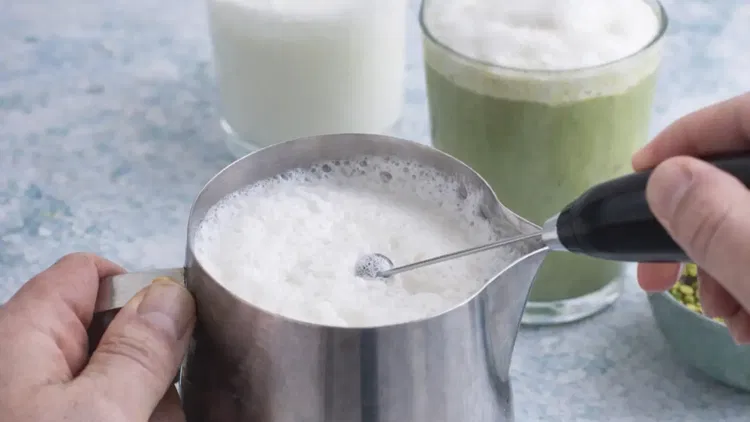 Image of For an iced pistachio matcha latte, fill a glass with...