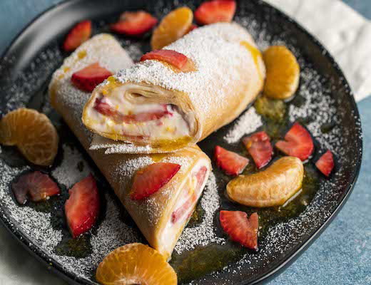 Image of Organic Strawberry Crepes with Pixie Tangerine Sauce