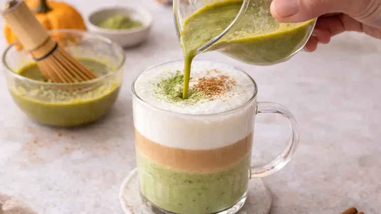 Image of Pour the sweetened milk into mugs. Slowly add the whisked...