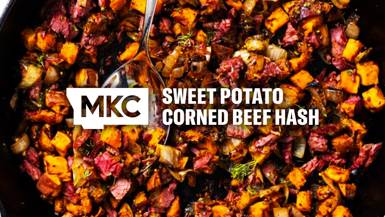 Sweet potato corned beef hash with diced sweet potatoes, chopped corned beef, onions, and herbs cooked in a skillet.