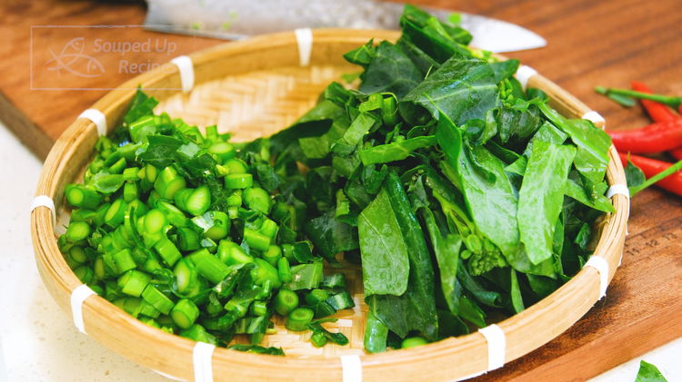 Image of Slice the Chinese broccoli (AKA gailan) stems into thin rounds...