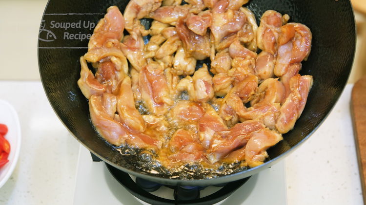Image of Add the marinated chicken and spread the pieces into a...