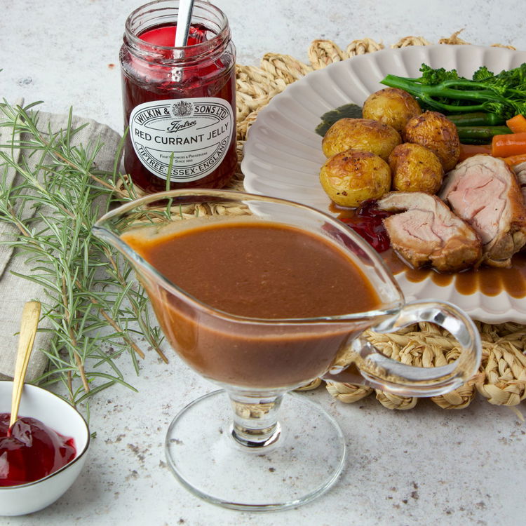 Image of Strain the gravy through a sieve into a warm serving...