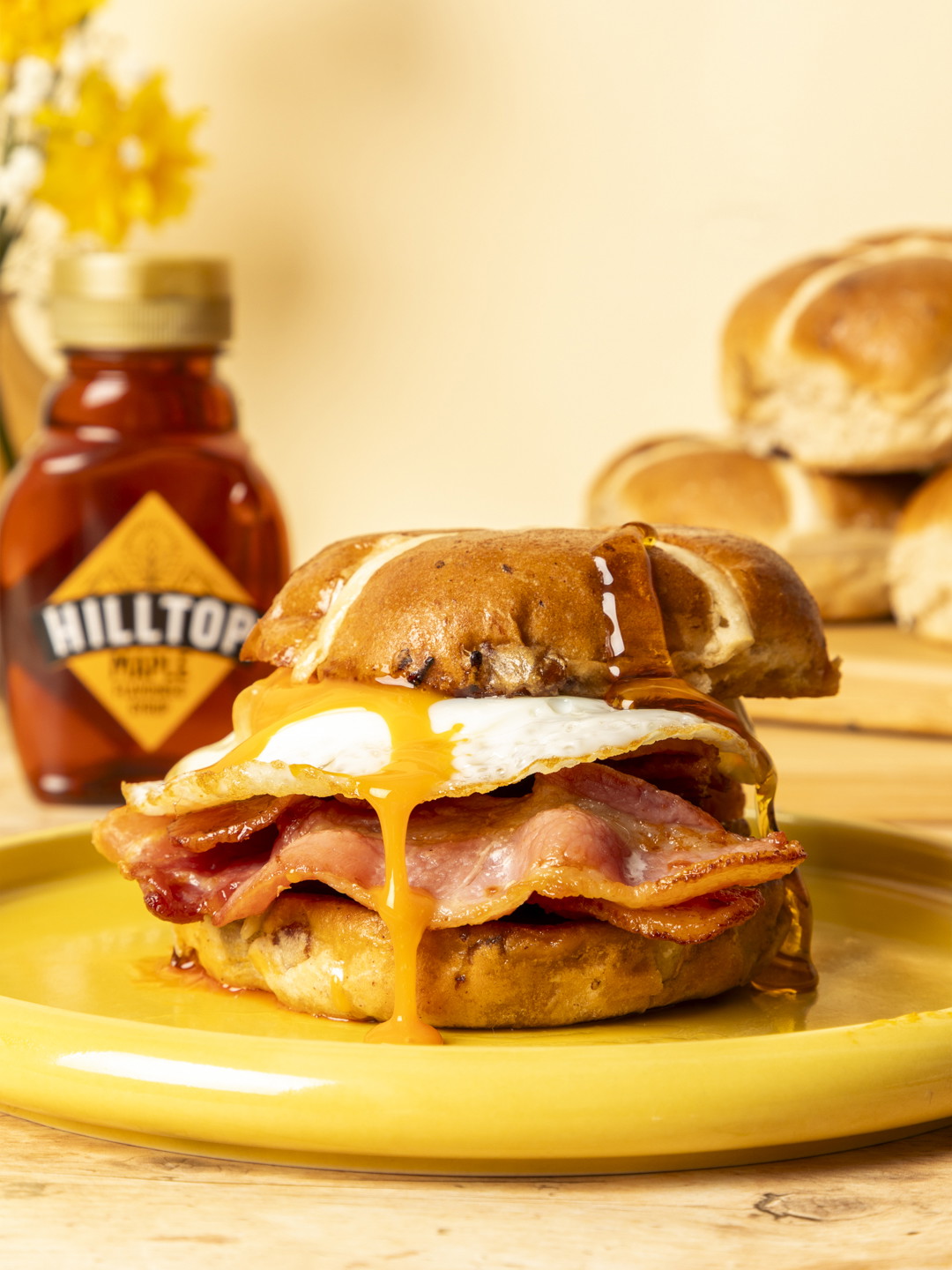 Hot cross bun bacon sandwich with maple syrup