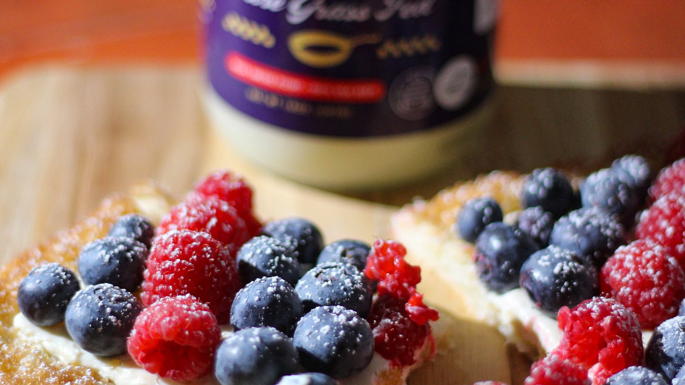 Festive summer tart featuring a crisp puff pastry base glazed with beef tallow, a creamy lemon-vanilla spread, and a vibrant topping of fresh berries.
