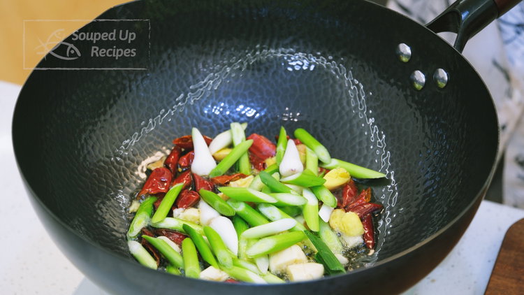 Image of Add the dried red chilies, diced garlic, ginger, and the...
