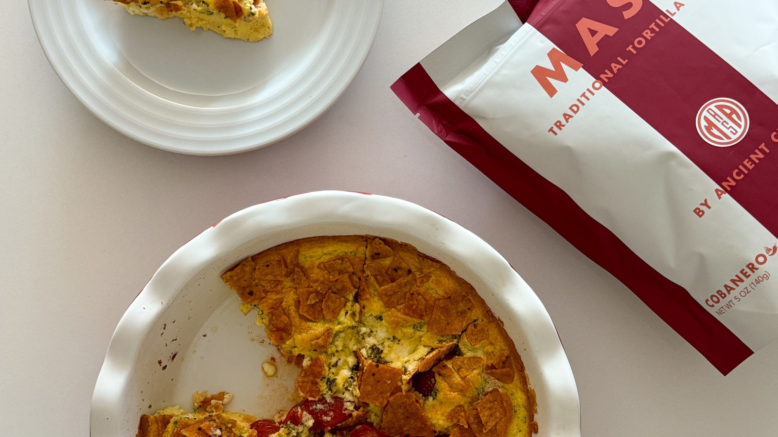 Light and fluffy egg frittata baked with savory feta and cherry tomatoes, then topped with crushed MASA Chips.