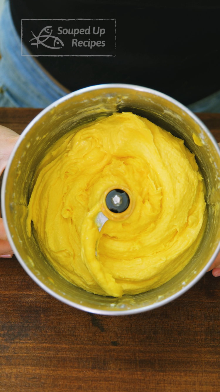 Image of Add the frozen mango cubes and milk powder to a...