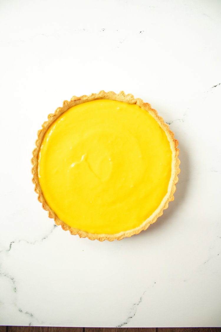 Image of Top with lemon slices, sprinkle powder sugar on top and...