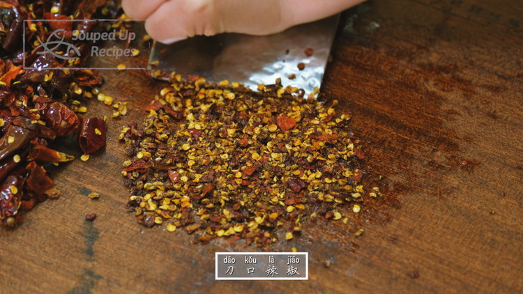 Image of Transfer to a cutting board and roughly chop. Keep chilies...