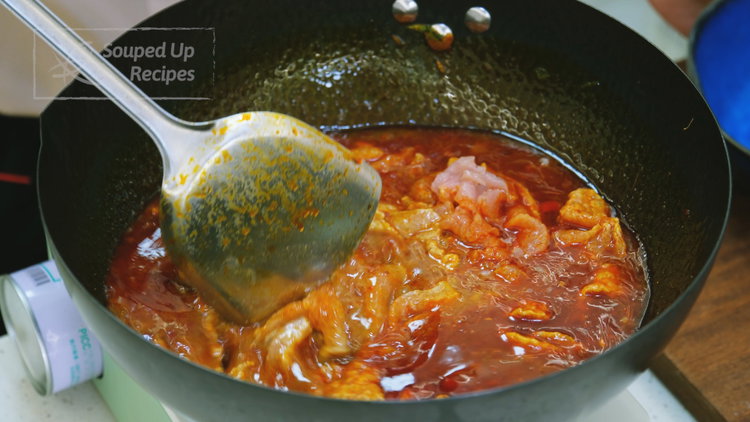 Image of Add marinated pork to the simmering broth. Gently stir to...