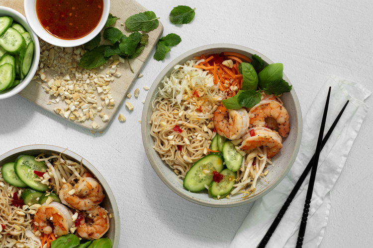 Image of Build the salads by arranging the noodles, cabbage, cucumbers, carrots,...