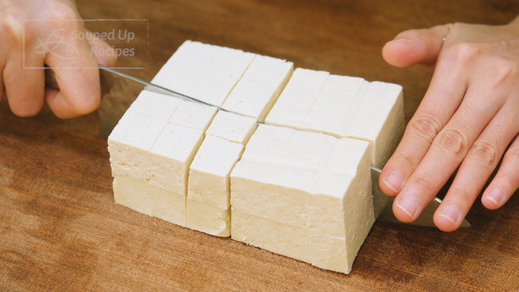 Image of Pat the tofu dry with paper towels and cut it...