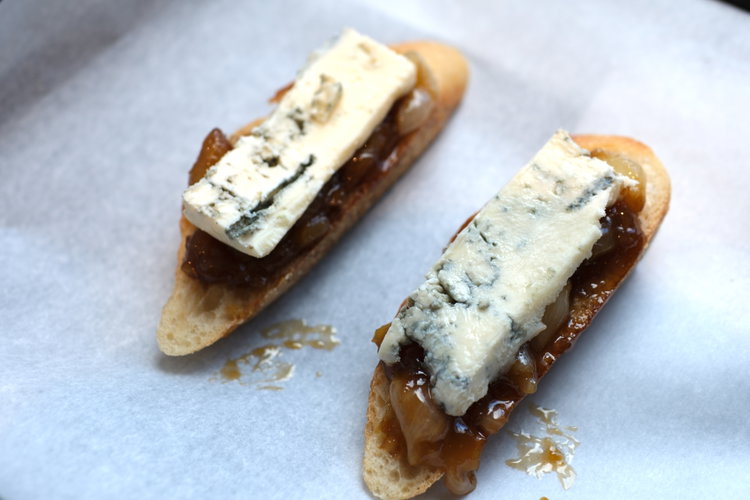 Image of Top with the broken apart glazed onions and crumbled gorgonzola.