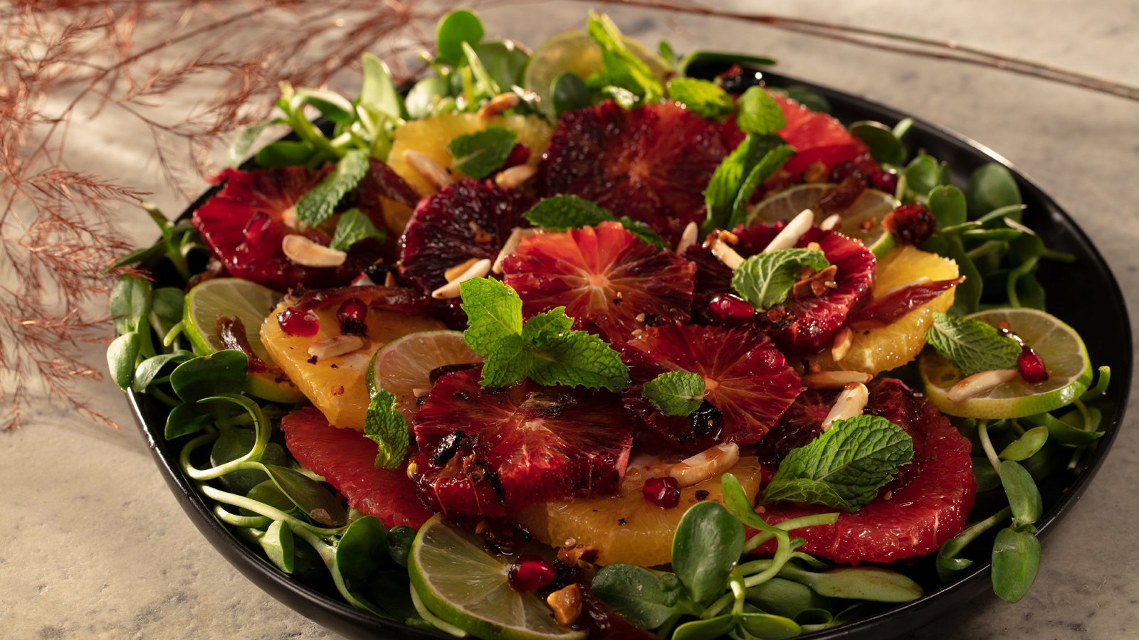 Citrus salad of blood orange, navel orange, pink grapefruit and limes with pomegranate molasses oo’mämē Chile Crisp, fresh mint, pomegranate arils and dates