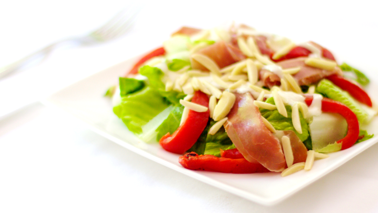Image of Salad With Prosciutto Roasted Red Peppers And Creamy Almond Dressing