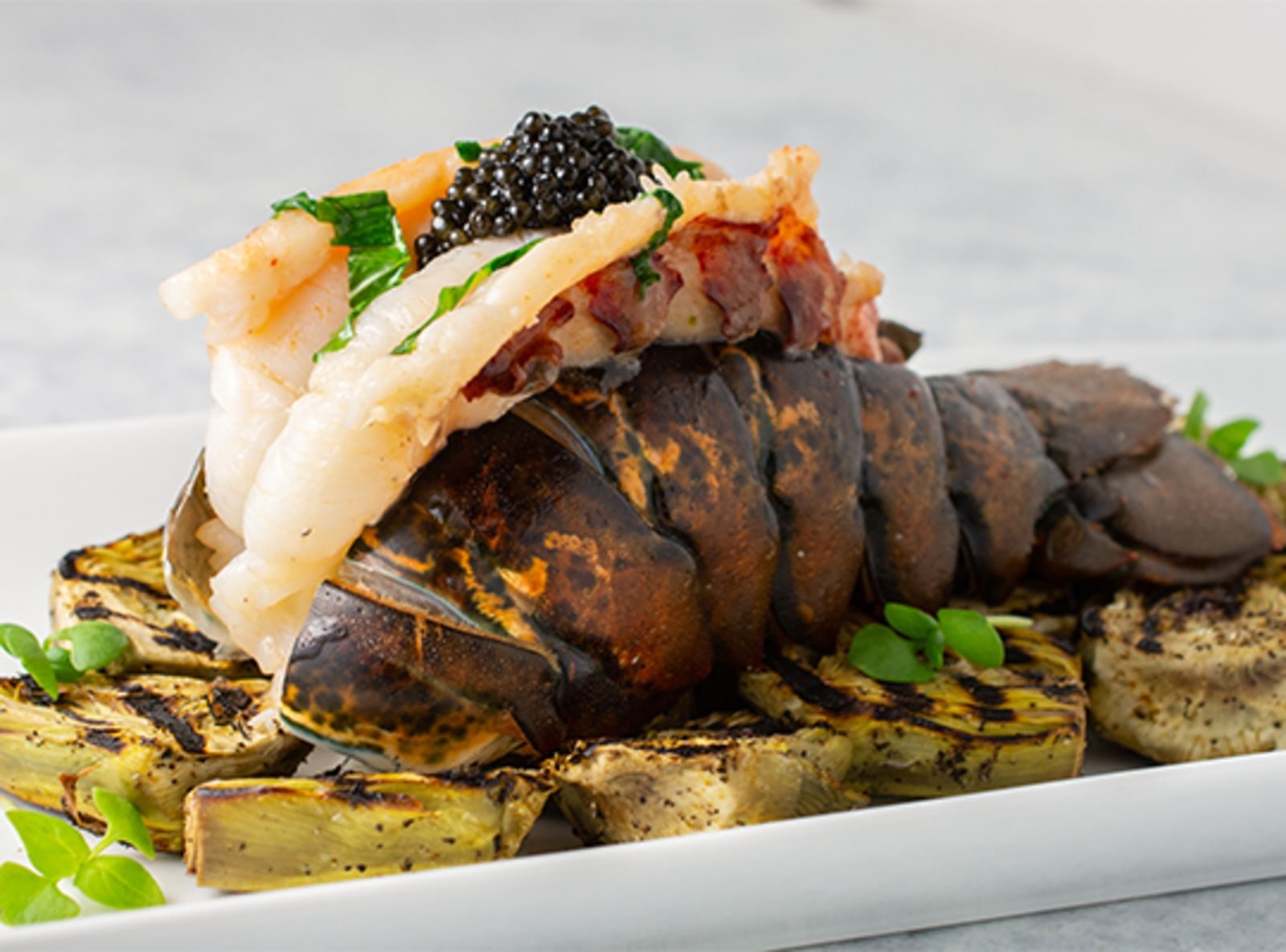 Basil Butter Poached Lobster with Grilled Baby Purple Artichokes and Caviar